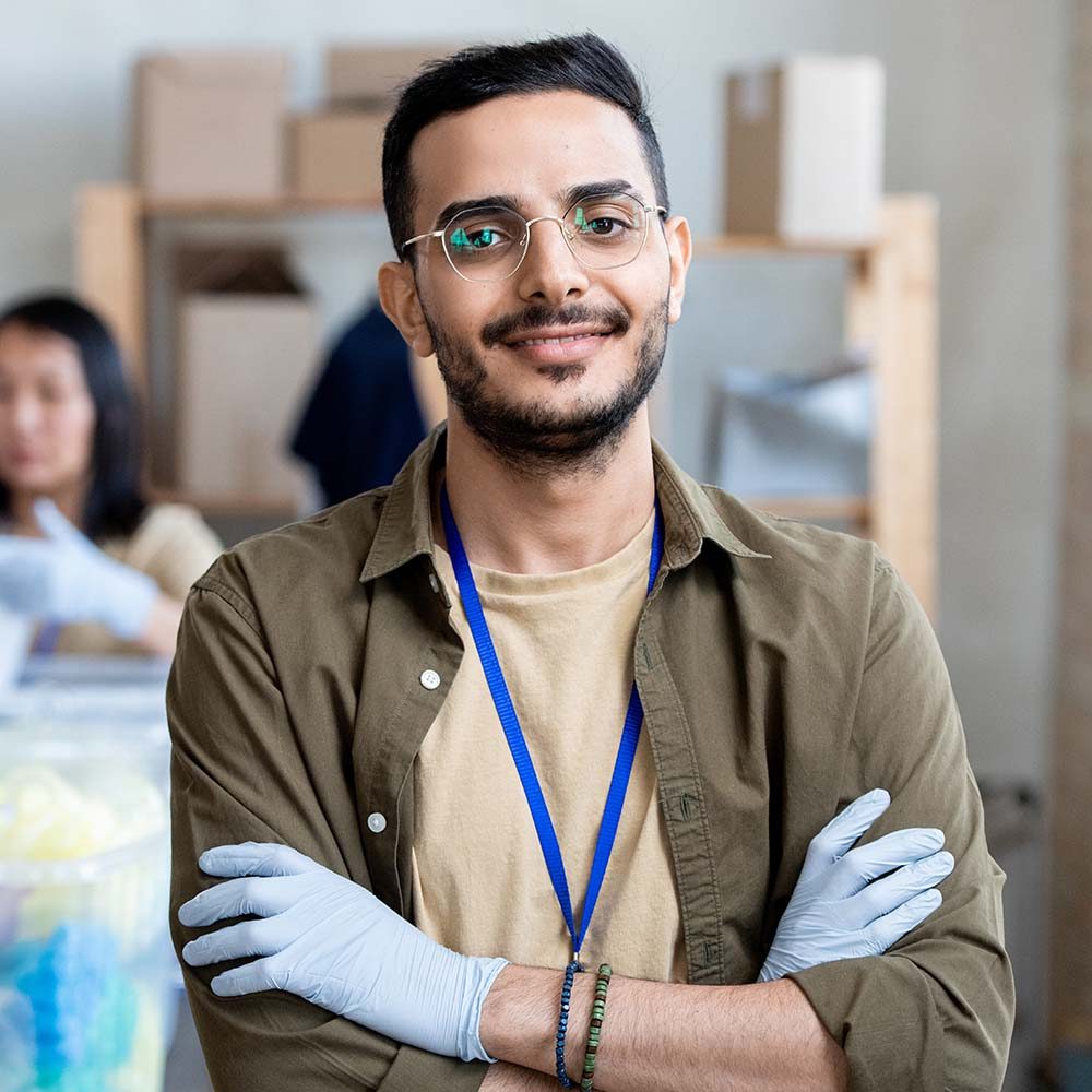 happy-young-man-standing-against-female-volunteer-ZD6H33Q.jpg